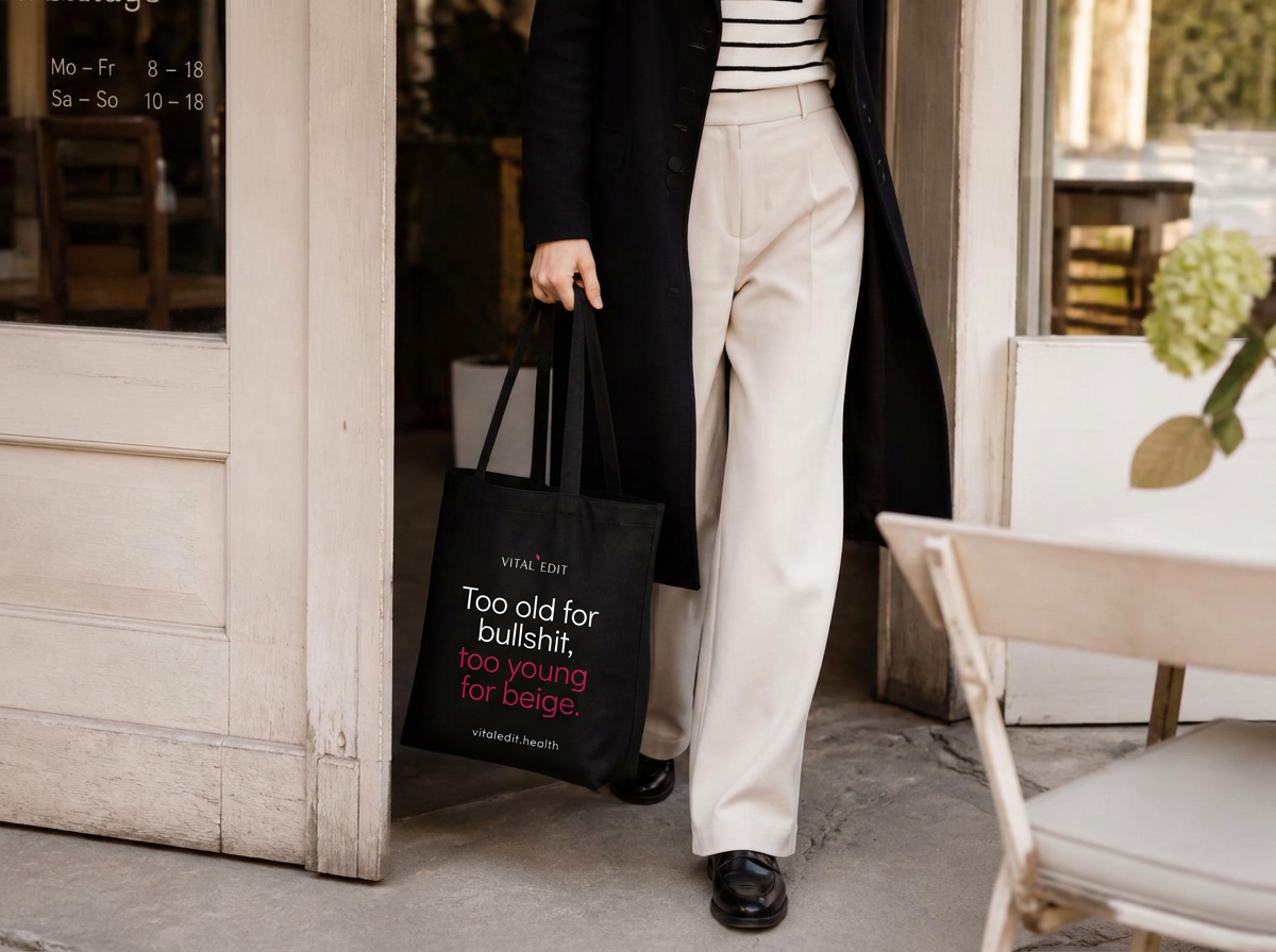 Woman leaving a Berlin cafe carrying a Vital Edit tote bag